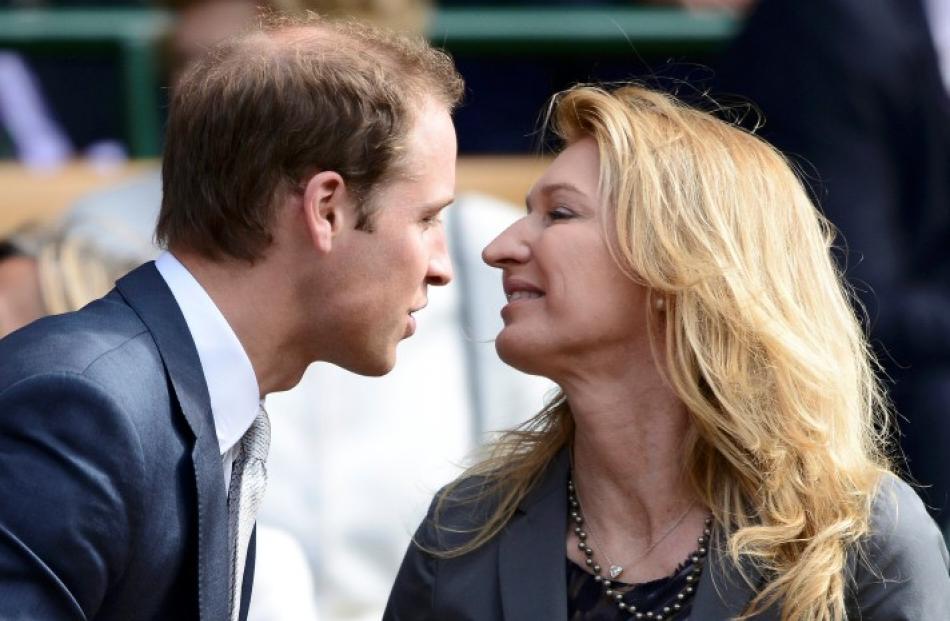 Britain's Prince William (L) greets former tennis player Steffi Graf on Centre Court for the men...