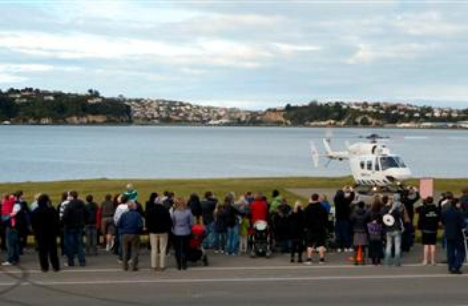 Hundreds queue at the Kitchener St heliport on Saturday for helicopter joyrides to raise funds...