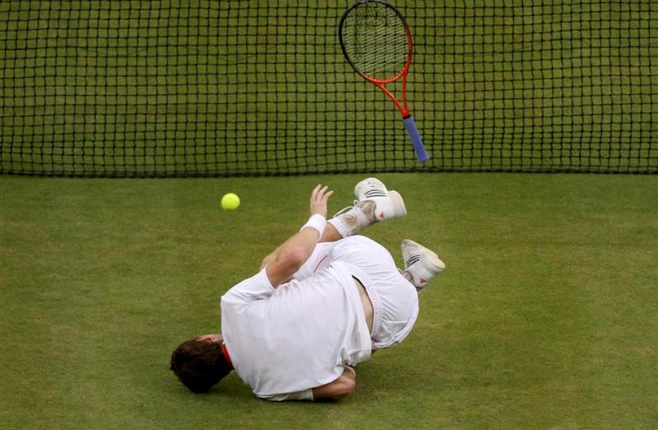 Andy Murray falls during his men's singles final tennis match against Roger Federer. REUTERS...