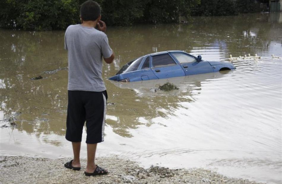 A car is submerged in a flooded street in a southern Russian village.