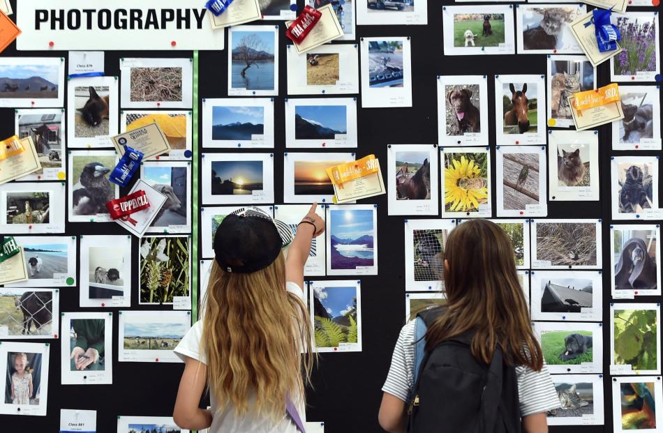 Admiring entries in the show’s photo competition were Jaime Taylor (left, 9) and Izzy Ashford (10...