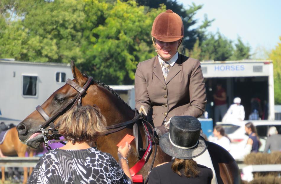 Rider Sophie Pickens, of Lincoln, receives the winning ribbon for the Open Paced and Mannered...