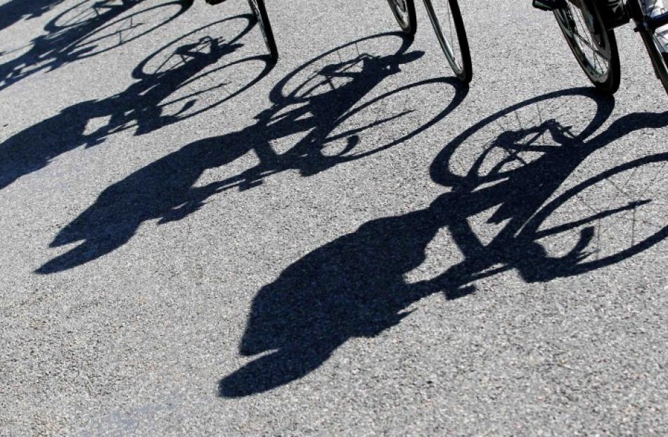 Riders cast shadows as they cycle during the 10th stage of the Tour de France. REUTERS/Bogdan...