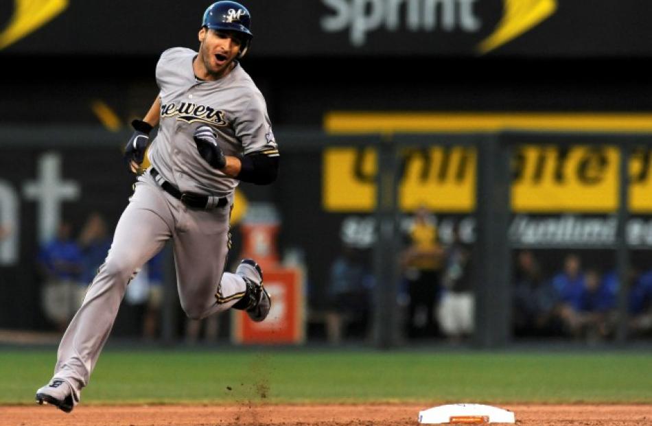 Ryan Braun of the Milwaukee Brewers rounds second base on his way to a triple against the...