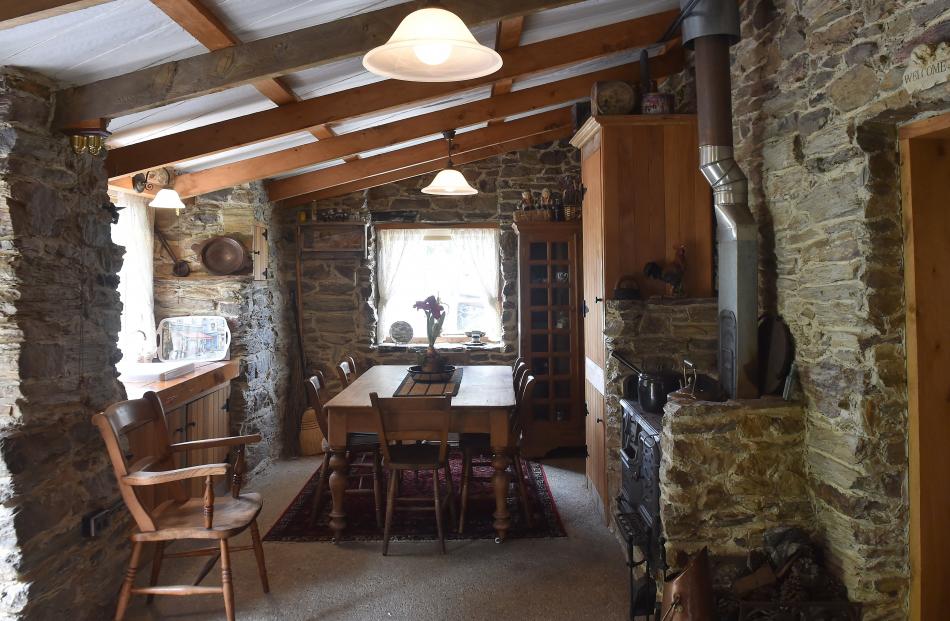The tall cupboard in the kitchen-dining area holds the hot water cylinder. The Shacklock range...