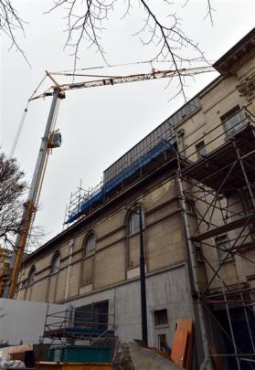 A crane towers over the Dunedin Town Hall as work, including the installation of air-conditioning...