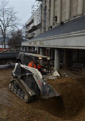 An excavator emerges from the bowels of the Dunedin Town Hall basement to scoop up another load...