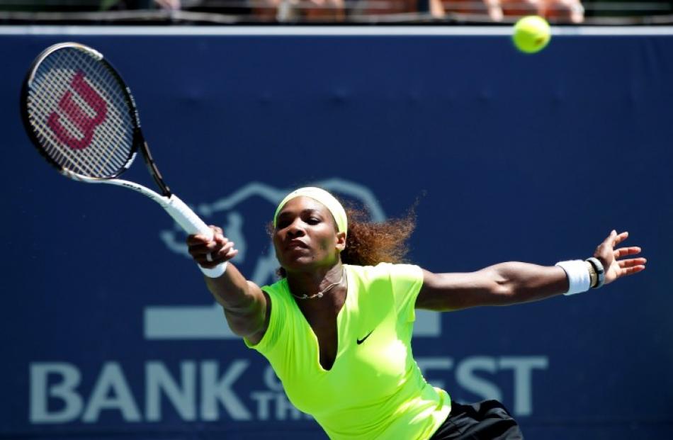 Serena Williams of the US reaches to hit a forehand shot against compatriot Coco Vandeweghe...