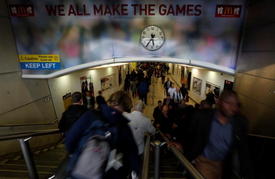 Commuters make their way through Stratford underground station near the site of the 2012 London...