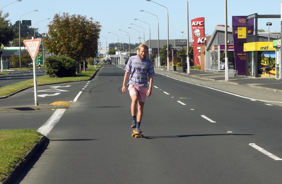 A skateboarder is king of the road on a clear run down Andersons Bay Rd during lockdown. PHOTO:...