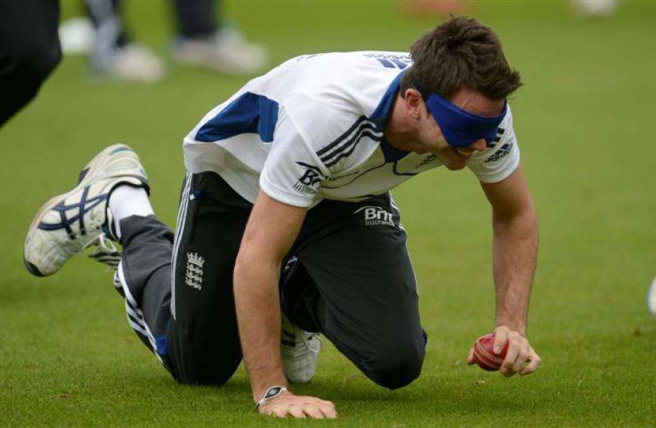 England's James Anderson picks up a ball while blindfolded during a training session. REUTERS...