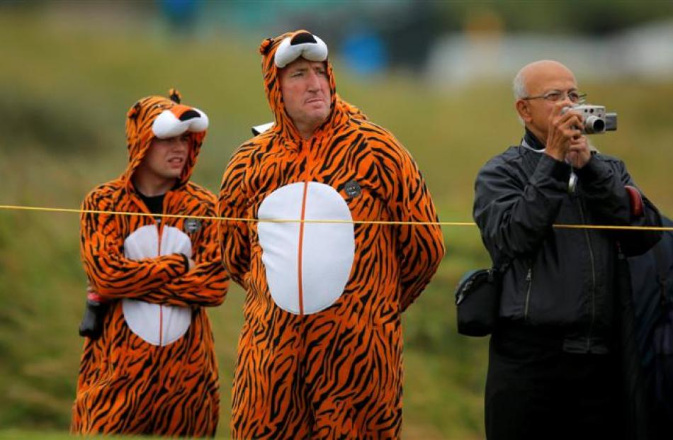 Fans dressed in tiger costumes watch play on the fifth hole during a practice round ahead of the...