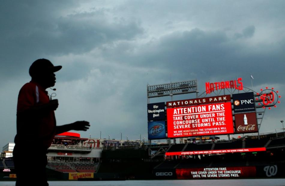 A security guard clears the field because of a predicted storm before the Washington Nationals v...