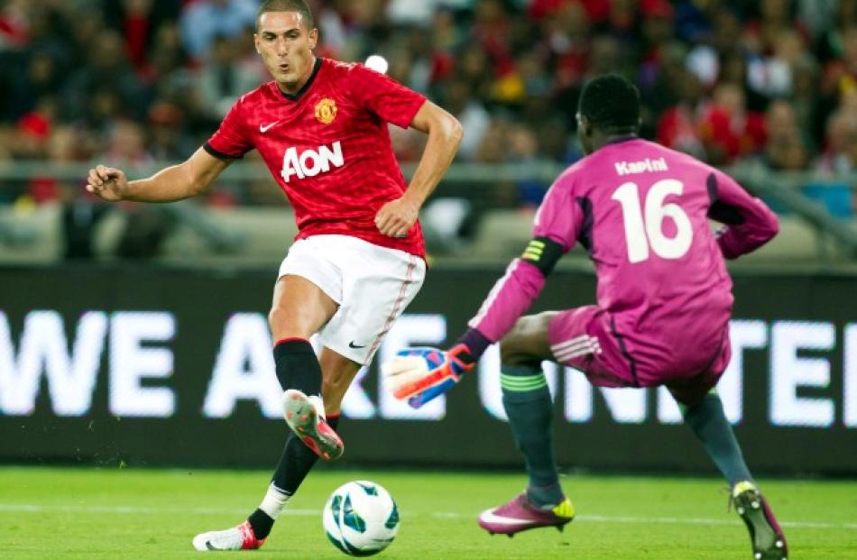 Manchester United's Federico Macheda (L) scores past Amazulu Football Club's Tapuwa Kapini during...