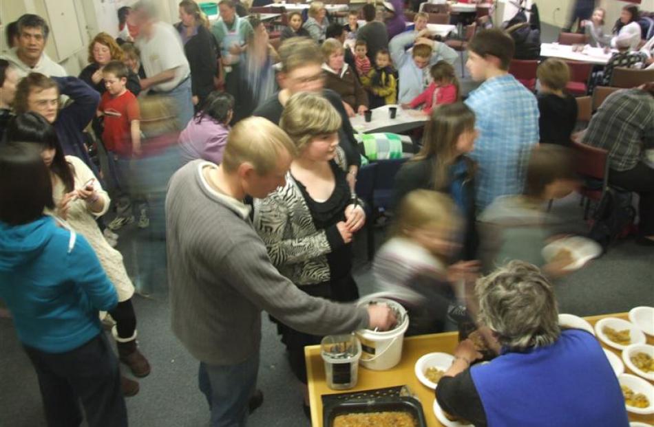 Brockville residents queue for dessert at this month's Sunday evening community dinner.