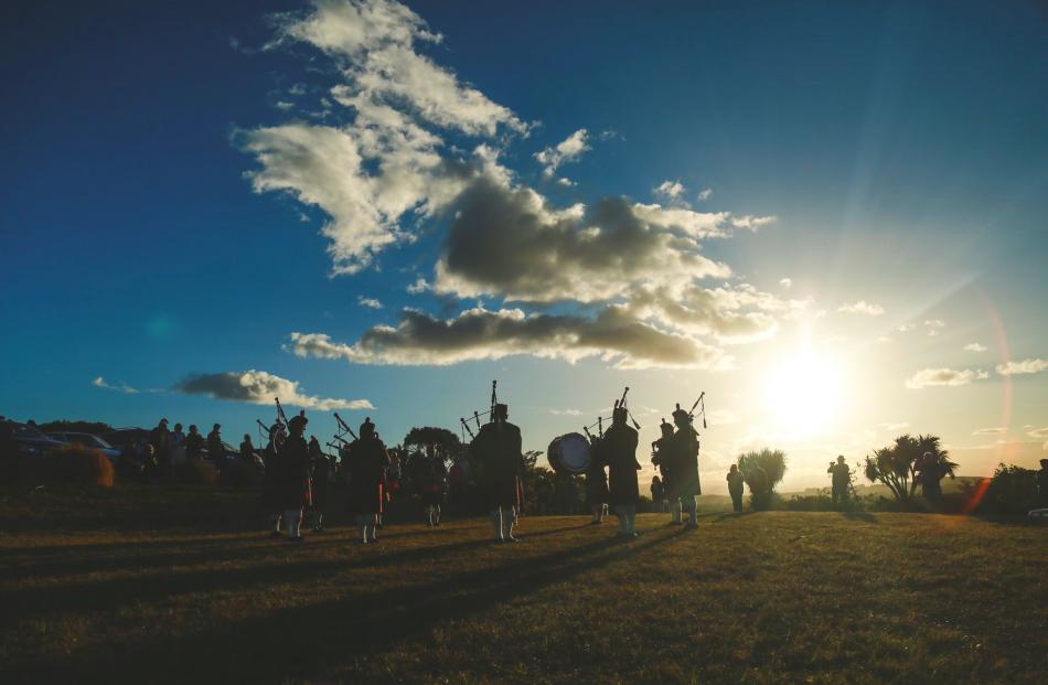 The North Otago Highland Pipe Band performs at Lookout Point in Oamaru at sunset on Good Friday. PHOTO: REBECCA RYAN
