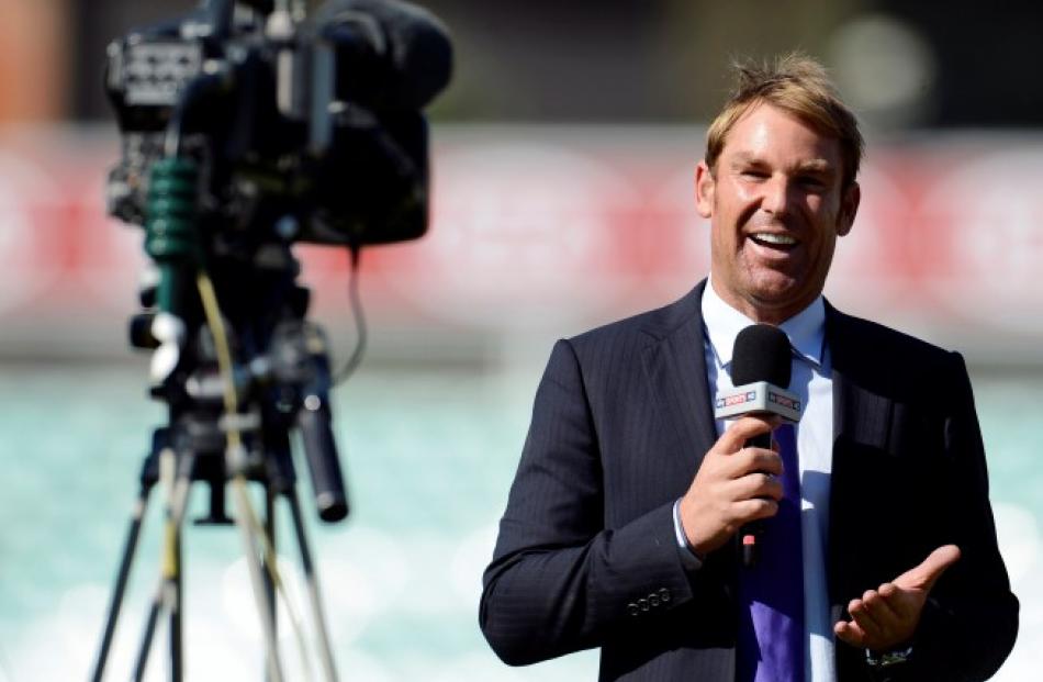 Commentator and former Australian cricketer Shane Warne faces a television camera after the first...