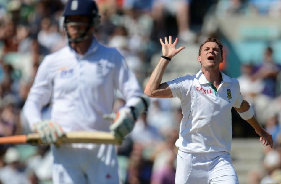 South Africa's Dale Steyn (R) celebrates after dismissing England's Graeme Swann for his fifth...