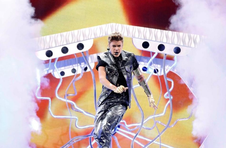 Singer Justin Bieber performs at the 2012 Teen Choice Awards at the Gibson Amphitheatre in...