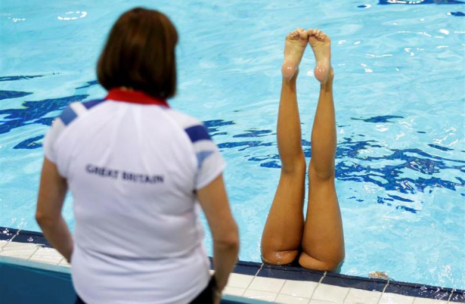 A member of the Team GB synchronised swimming team trains. REUTERS/Tim Wimborne