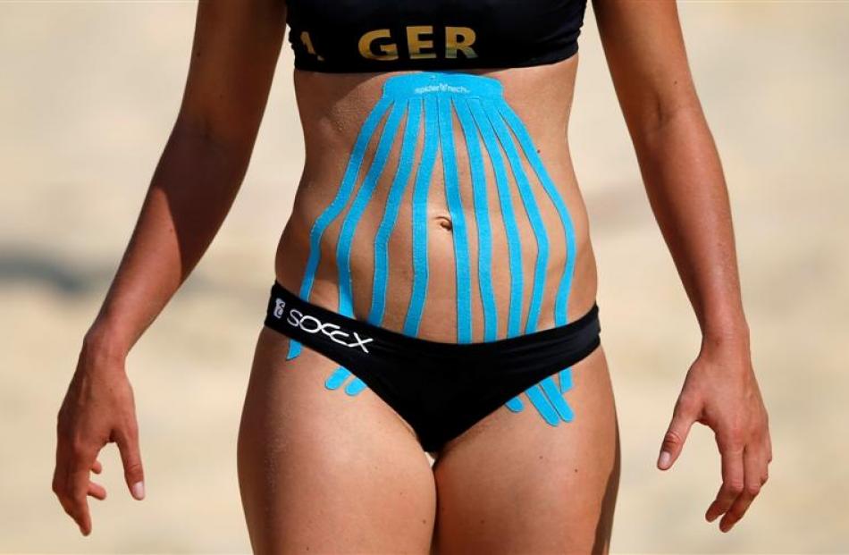 Germany's Katrin Holtwick takes part in a practice session with kinesio tape on her stomach at...