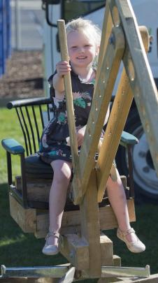 Having a go on a digger made by Ashford Landscaping staff from recycled materials is Annabelle...