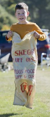 Jumping towards the finish line during a sack race is William Hardisty (8).