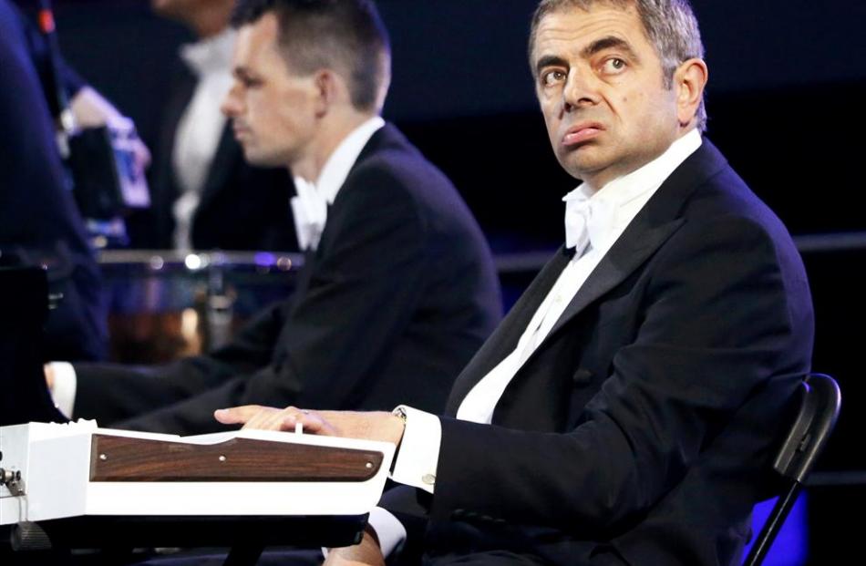 Actor Rowan Atkinson, known for his role as Mr Bean, performs during the opening ceremony.  ...