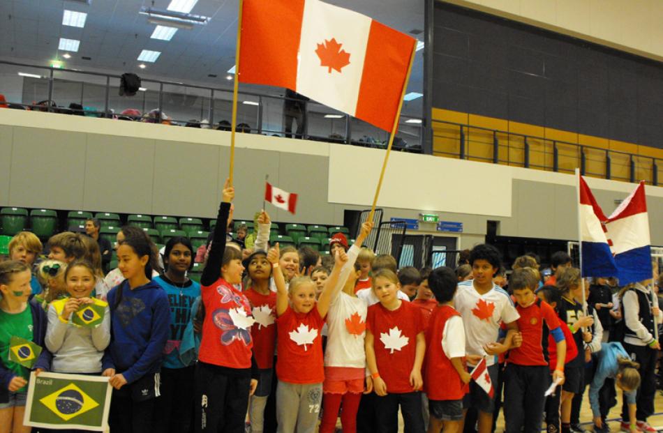 The pupils represented the countries competing in the Olympics. Queenstown Primary pupils hold...