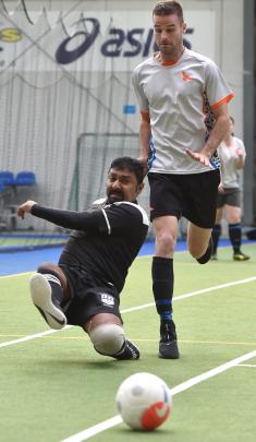 Amish Chard, of Hauraki Plains School, shoots for goal while Mark Jones, of Rototuna High School,...