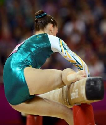 Georgia Bonora of Australia slips as she competes on the balance beam during the women's...