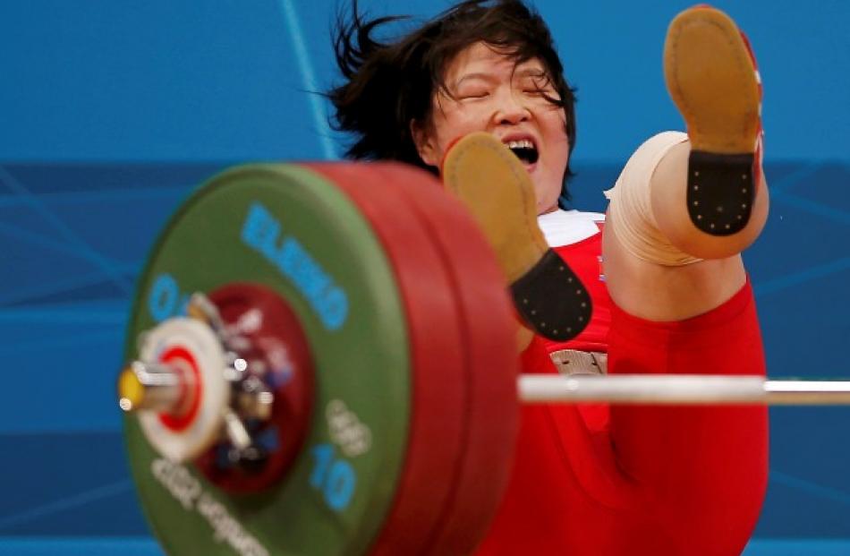 North Korea's Jong Sim Rim falls after failed attempt on the women's 69kg Group A weightlifting...