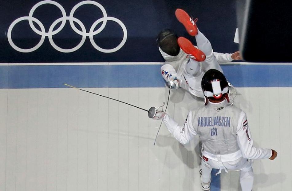 South Korea's Choi Byungchul (top) falls down as he competes against Egypt's Alaaeldin...