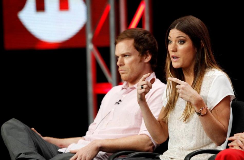 Jennifer Carpenter speaks nest to co-star Michael C. Hall at a panel for 'Dexter' during the...