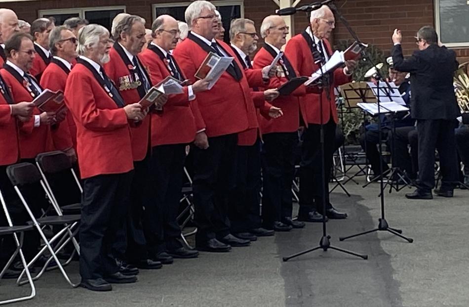 The Dunedin RSA Choir stand to sing during the Montecillo Anzac Service. PHOTO: BRENDA HARWOOD