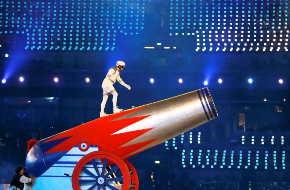 A performer prepares to climb into a giant cannon. REUTERS/Phil Noble