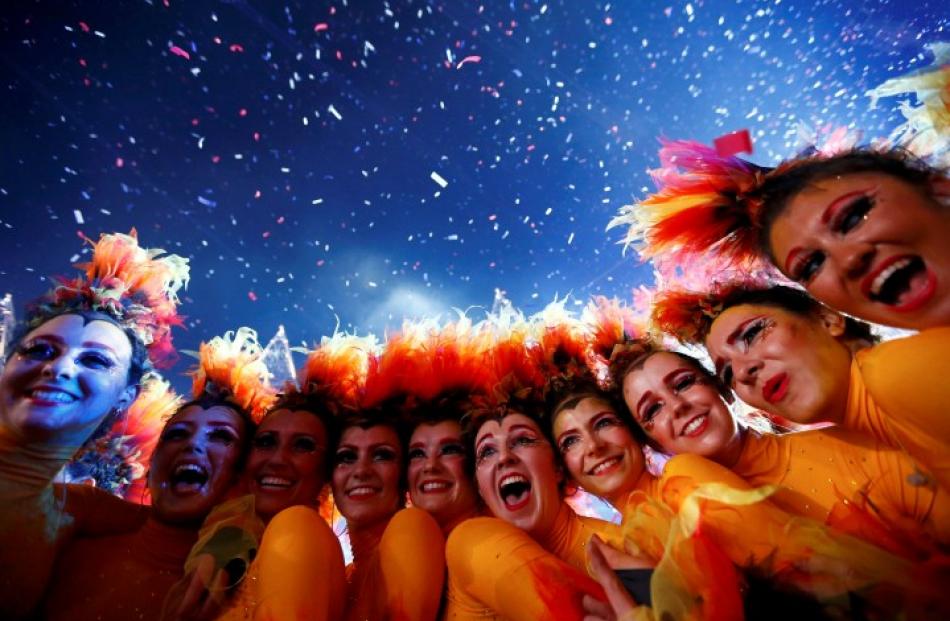 Performers enjoy the atmosphere at the end of the ceremony. REUTERS/Kai Pfaffenbach