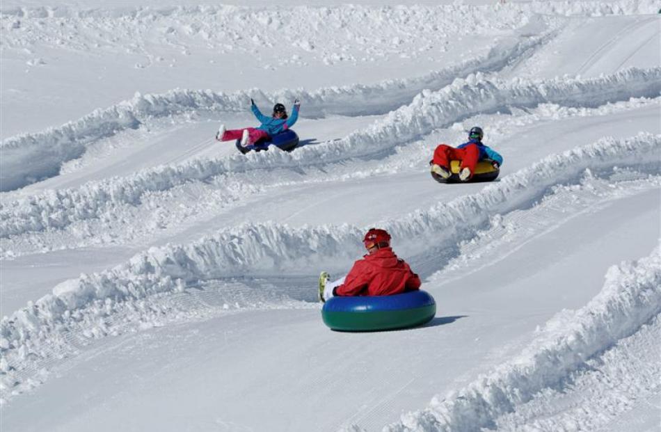 Snow tubers race down the lanes at the Remarkables tubing park. Photo by Tony Harrington.