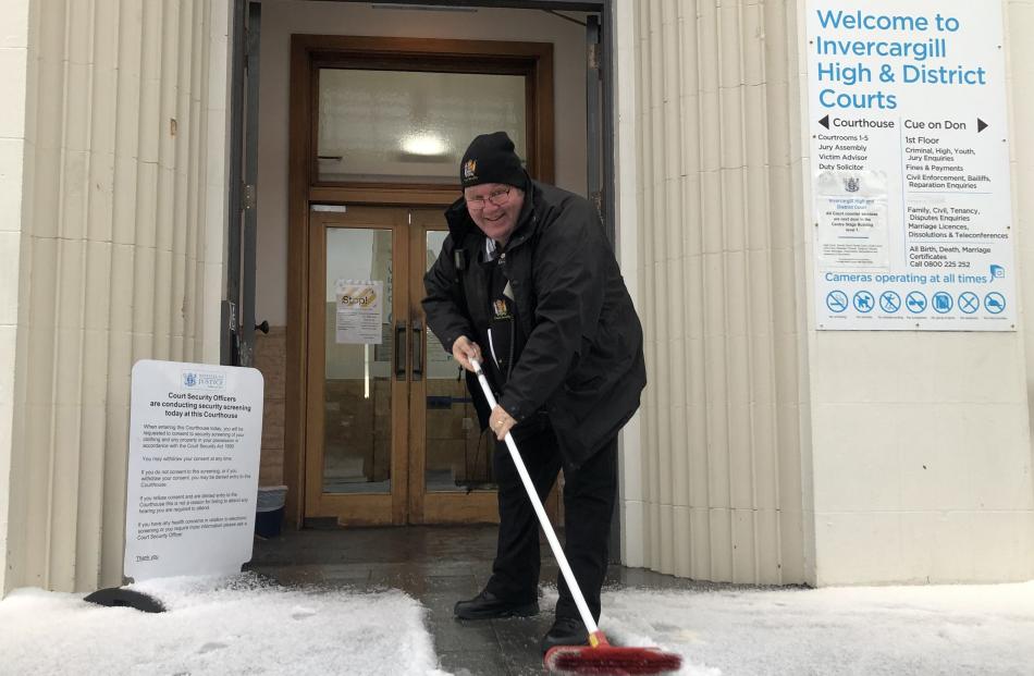 Invercargill High Court and District Court security guard Stewart Saunders clears the entrance to...