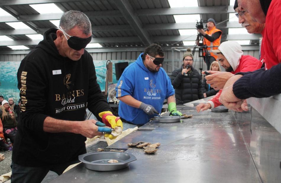 Ricci Grant and KZ Matangi take part in the blindfolded oyster-opening competition.