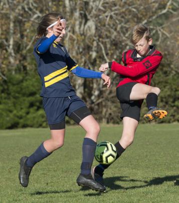 Battling it out in the final minutes of their game are Melchester Rebels player Charlotte Summers...