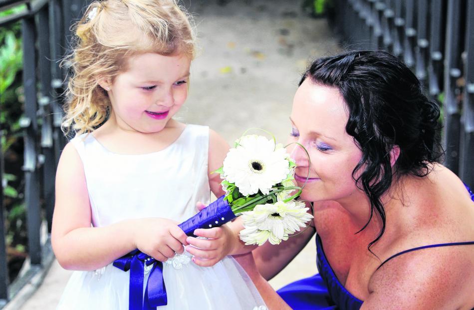 The flower girl and bridesmaid at the February wedding of Stephanie McLoed and Rick Dunphy at...