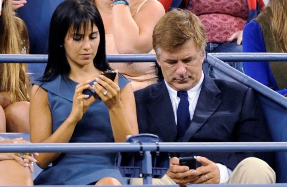 Actor Alex Baldwin (R) and wife Hilaria Thomas attend the opening night matches at the US Open...