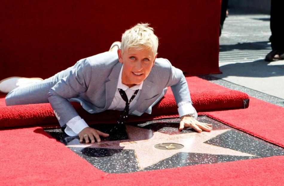 Television personality Ellen DeGeneres touches her star after it was unveiled on the Walk of Fame...