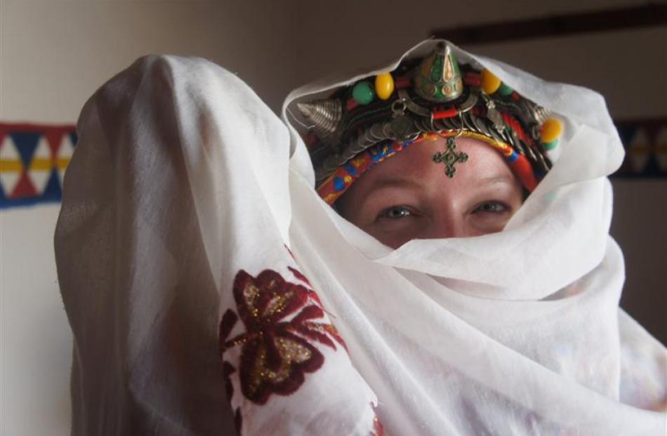 A Dutch visitor tries on traditional Berber wedding garb.