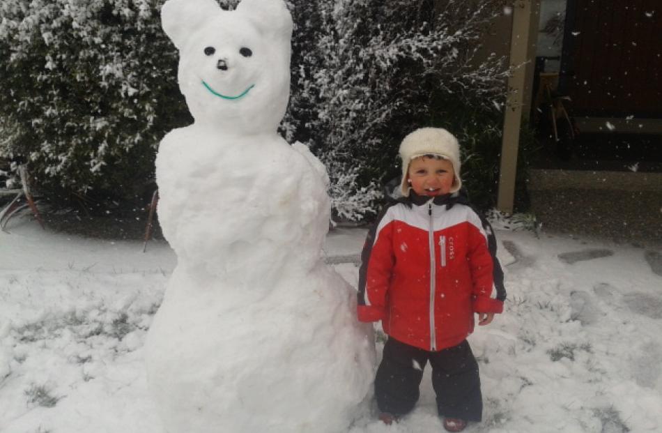 Cooper Breen (2) with his giant snow bear at his Quail Rise home.  Photo by Laurel Breen
