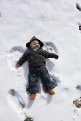 Snow angel . . . Cameron Mullan (8 months), of Arrowtown, makes his first snow angels following a...