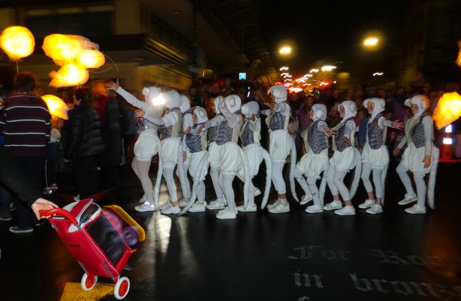 Dancers dressed as mice perform in the carnival procession.