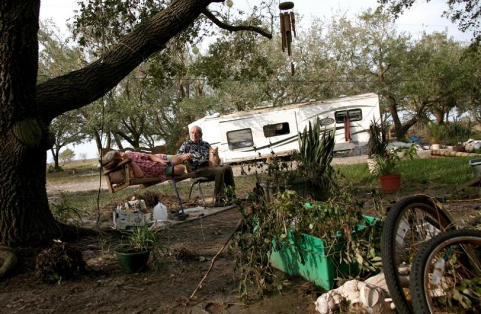 Al Lasseigne, 81, rocks his ex-wife, Ruby Lasseigne, in a tree swing on Monday across the road...