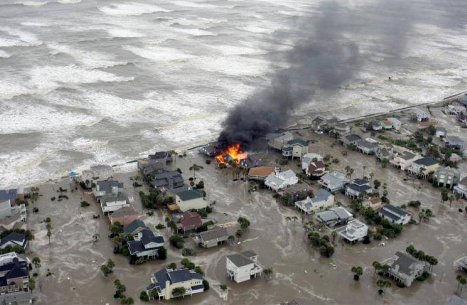 Fire destroys homes along the beach on Galveston Island, Texas as Hurricane Ike approaches, on...